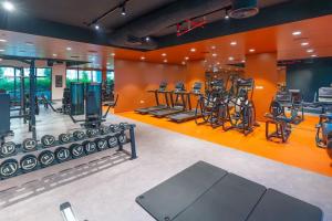 a gym with several treadmills and elliptical machines at Azure Escape !Joyful 1 Bed Apartment close to the Sea! in Dubai