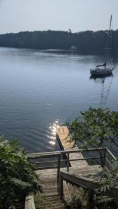 un barco sentado en el agua junto a un muelle en Stunning lakefront 4 season cottage in PEC en Bongards