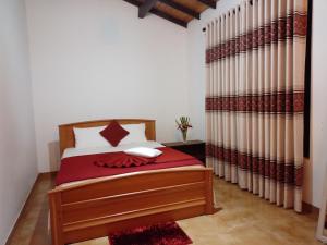 En eller flere senge i et værelse på Pebbles Holiday Bungalow Bandarawela