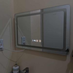 a mirror on the wall of a bathroom at CityLofts Plainview in Mandaluyong corner unit in Manila
