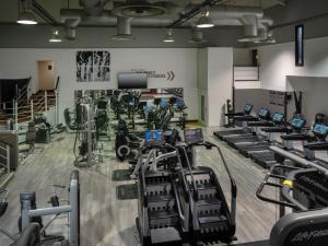 a gym with rows of treadmills and machines at Delta Hotels by Marriott St Pierre Country Club in Chepstow +119 photos