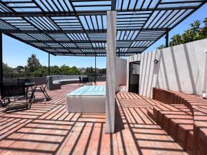 a patio with a pool and a pergola at Suite a 15 minutos de Polanco y Santa Fe in Mexico City