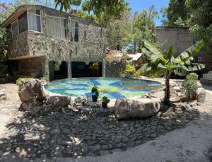a house with a swimming pool in front of a house at LA CASA DE LOS MANGOS AJIJIC in San Antonio +9 photos
