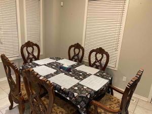 a dining room table with a quilt on top of it at Adorable Ajax House for Rent in Ajax