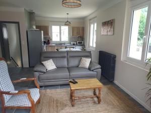 a living room with a couch and a coffee table at le gite du Montcalm in Auzat