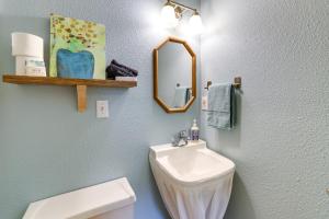 a bathroom with a sink and a mirror and a toilet at Lakefront Cottage by Little Golden Gate Bridge in Eureka Springs +16 photos