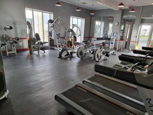 a gym with treadmills and machines in a room at Lucy's Lodge in Rhyl