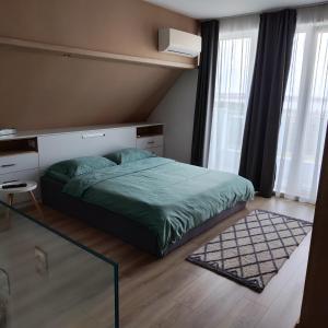 a bedroom with a bed and a glass table at AirLuxApartament in Burgas City