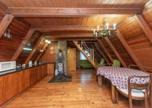 a dining room with a table and a kitchen at Domek Widok in Międzybrodzie Bialskie