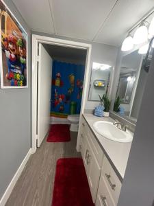 a bathroom with a sink and a toilet and a mirror at Hollywood Apartment One Bedroom with Mario in Los Angeles
