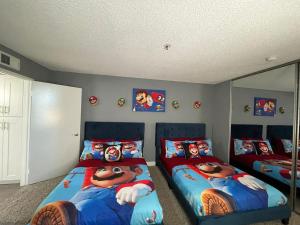 a bedroom with two beds and a mirror at Hollywood Apartment One Bedroom with Mario in Los Angeles