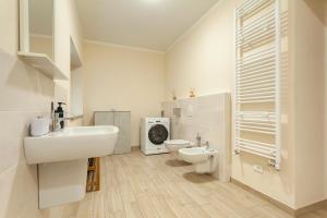 a white bathroom with a sink and a toilet at Veruskacamere Camera 1 in Somma Lombardo