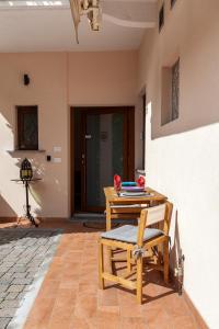 a patio with a table and a chair and a camera at Veruskacamere Camera 1 in Somma Lombardo