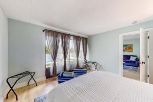a bedroom with a bed and a large window at Capri 102 in Marco Island