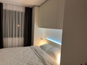 a bedroom with a white bed and a window at Jahorina Apartment4Two in Jahorina