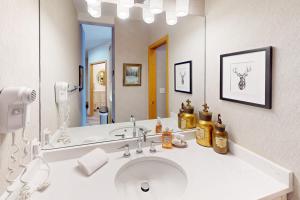a bathroom with a sink and a large mirror at River Bank Lodge 2924 in Keystone +35 photos