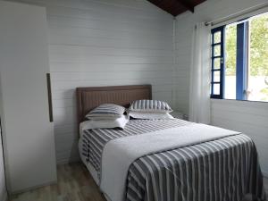 Ein Bett oder Betten in einem Zimmer der Unterkunft Recanto do Mar