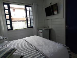 Ein Bett oder Betten in einem Zimmer der Unterkunft Recanto do Mar
