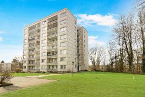 a large apartment building with a grassy field in front of it at Wohnung mit Balkon in Wuppertal in Wuppertal