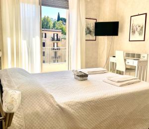 a bedroom with a large white bed with a window at Le Ville Suites, Tivoli City Center! in Tivoli