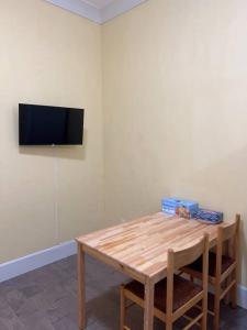 a room with a table and a television on a wall at Entire Guest Suite - 1 bedroom w/ Private Entrance in Surrey
