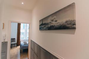 a living room with a large painting on the wall at Modern apartment in Aberdeen City Centre, Guild street, free WiFi in Aberdeen