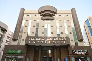 a building with a sign for a hotel at Al Furat Madayin Hotel in Riyadh