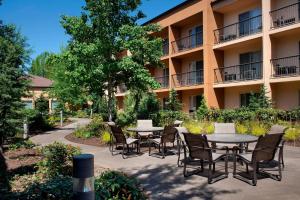 a patio with tables and chairs in front of a building at Courtyard by Marriott Portland Hillsboro in Hillsboro