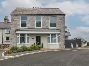 a house on a street with a driveway at 1 Dulas Apartments in Abergele
