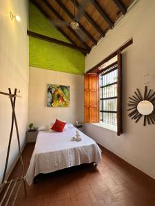 A bed or beds in a room at Maria Mulata Boutique Hotel