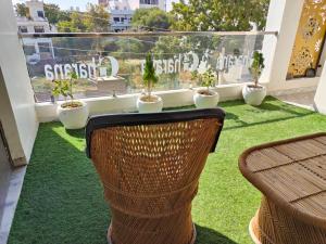 a balcony with a table and chairs on the grass at Gharana in Udaipur