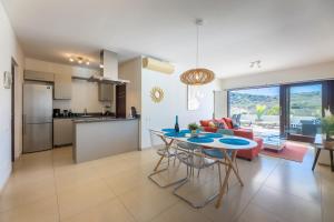 Dorp Sint Michiel的住宿－Green View at Blue Bay Golf & Beach Resort，厨房以及带桌椅的起居室。