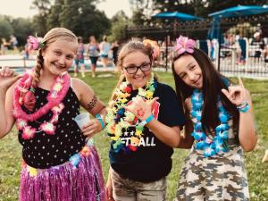 three girls are posing for a picture at a park at Jellystone Park Tower Park Resort in Lodi +58 photos