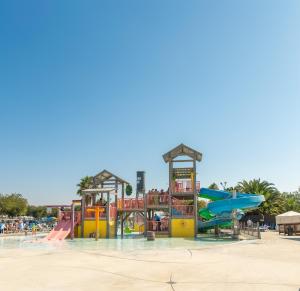 a water park with a playground with a slide at Jellystone Park Tower Park Resort in Lodi