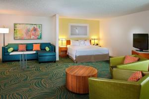 a hotel room with a bed and a couch at SpringHill Suites by Marriott Orlando Lake Buena Vista in Marriott Village in Orlando