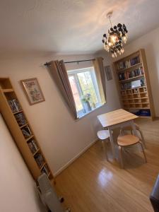 a dining room with a table and a window at Cardiff Bay Apartment in Cardiff