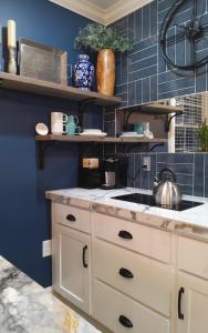 a kitchen with blue walls and a stove top oven at Chans Lakeside Hideaway in Stone Mountain