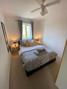 a bedroom with a large bed and a window at Cardiff Bay Apartment in Cardiff