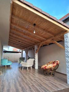 een woonkamer met een houten plafond en een bank bij Casa de langa lac in Oradea