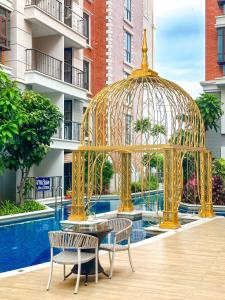 a gold gazebo with two chairs and a table at Espana Condo Resort Pattaya F108 in Jomtien Beach