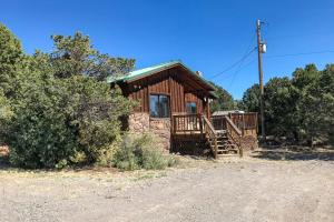 a log cabin with a porch and a porch at The Buck House in South Fork