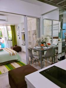 a room with a dining table and a bedroom at Holiday Escape Philippines in Manila