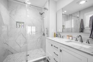 a white bathroom with a shower and a sink at 114 Salt Marsh Road East Sandwich Seaglass in East Sandwich +43 photos