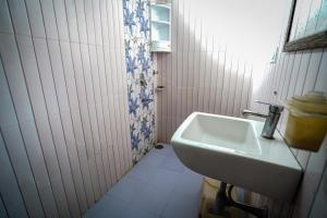 a small bathroom with a sink and a shower at HOTEL ATHITI INN JAIPUR in Jaipur