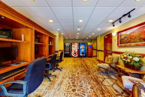 a conference room with chairs and a table and a television at Lion Square Lodge in Vail