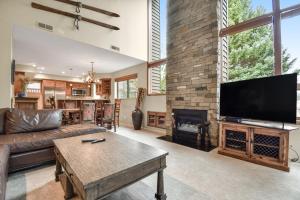 a living room with a couch and a fireplace at Red Pine Canopy in Park City