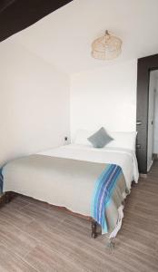 a large white bed in a white room at Oceana Surf Camp in Taghazout