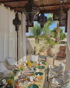 a table with plates of food on it on a patio at Riad des Fragrances dar el Bacha in Marrakech