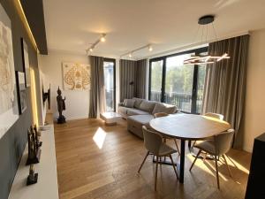 a living room with a table and a couch at Araliya in Kraków