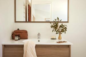 a bathroom with a sink and a mirror at Lodge Apartment 21 The Stables Perisher in Perisher Valley
